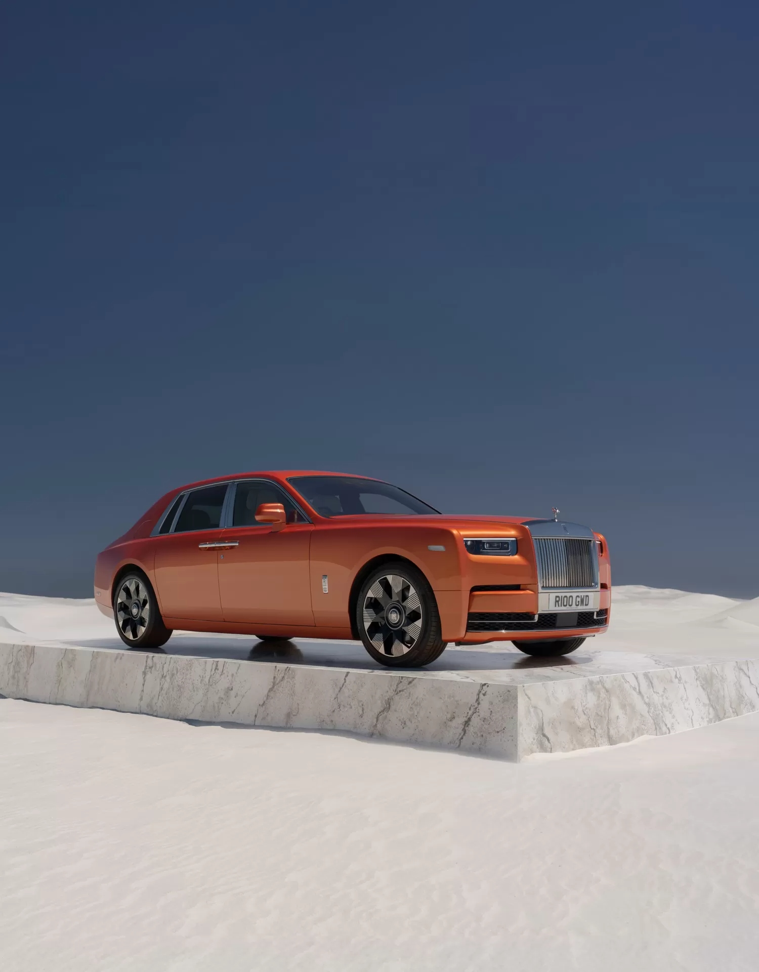Orange ultra-luxury sedan on a marble platform in a desert setting
