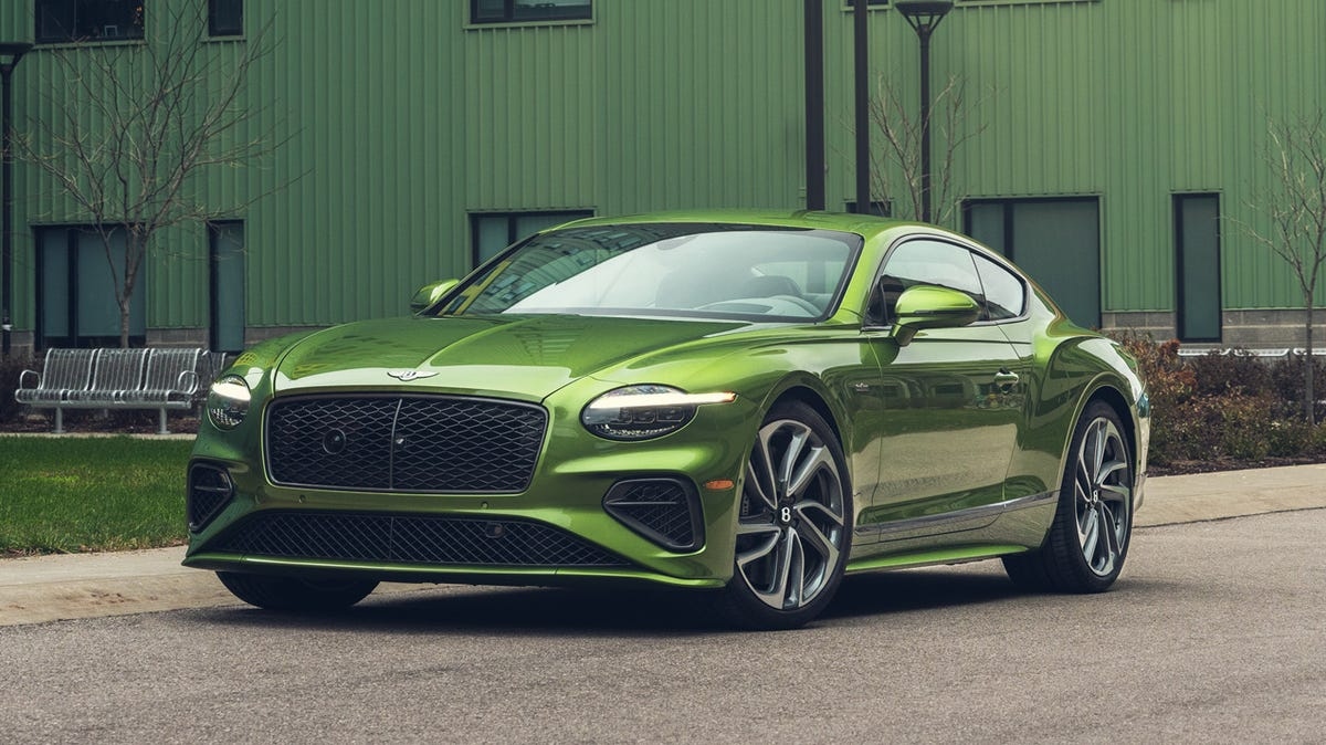 Green Bentley Continental GT luxury coupe parked outdoors, highlighting its bold exterior design, premium craftsmanship, and high-performance grand touring appeal.