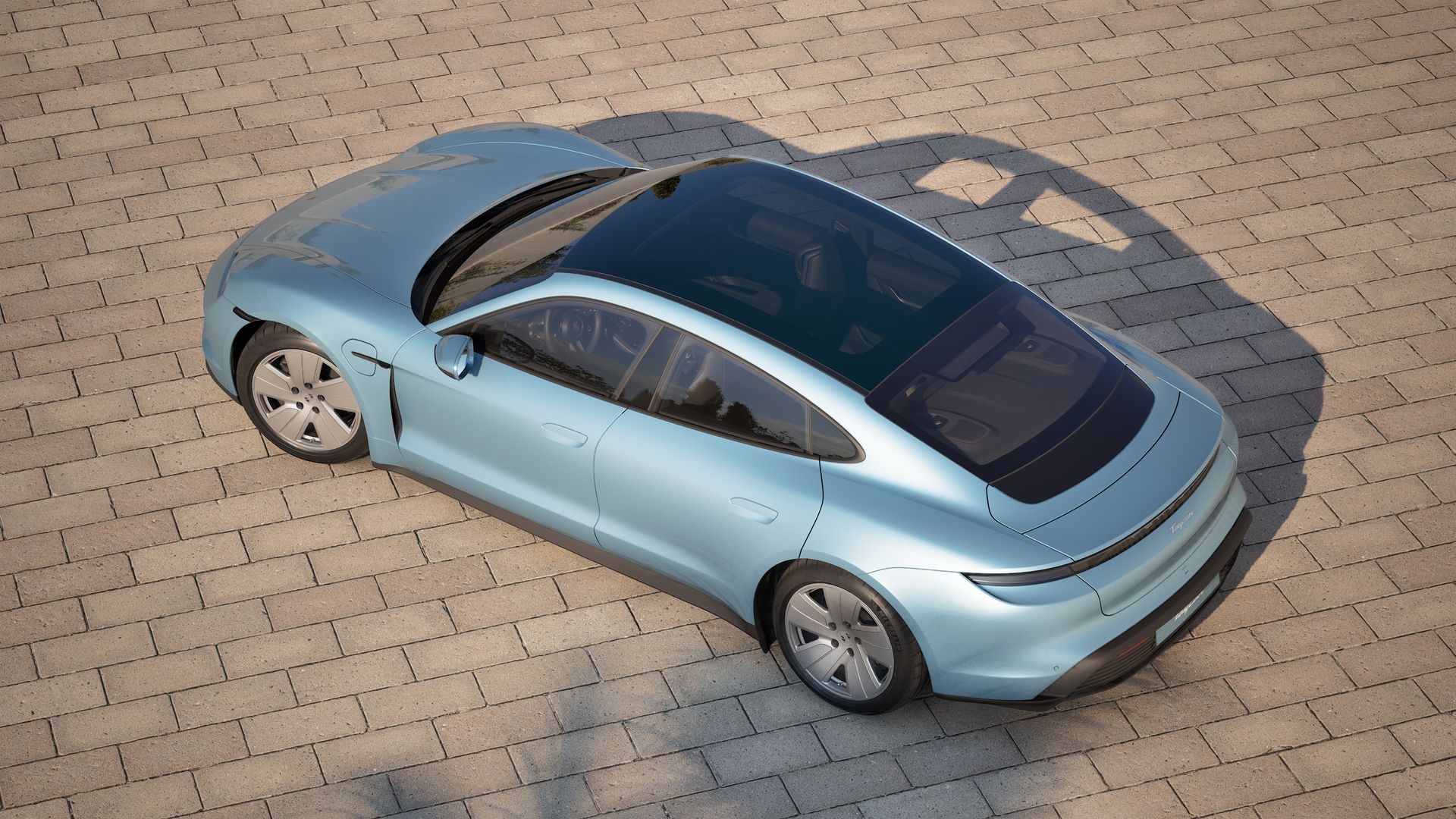 Top-angle view of Porsche electric sedan showcasing panoramic glass roof