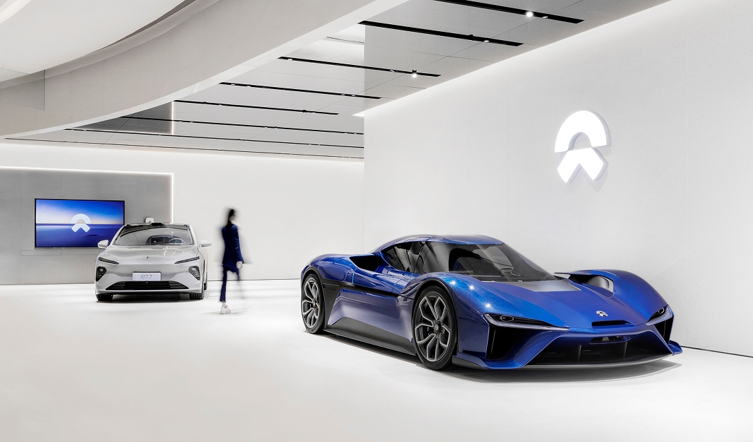 NIO electric SUV in blue, shown from the side with both wheels visible, highlighting its sleek Chinese tech-luxury design.